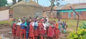 students standing near their school water tank