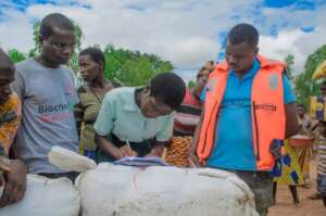 Village leader signs for bale of blankets