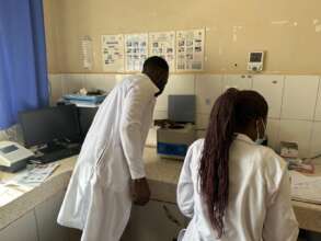 Laboratory technicians working with new centrifuge