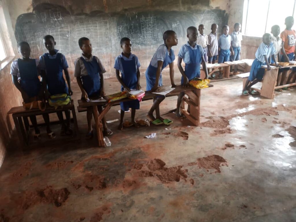 Pupils in their classroom without chairs