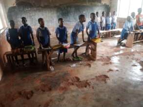 Pupils in their classroom without chairs