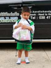 A rural student receiving supplies
