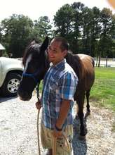 Brandon working with horses as volunteer