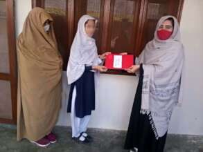A student receives her award