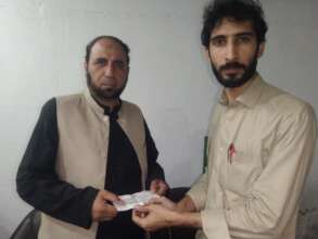 Director Fida Hussain gives the cheque to dealer