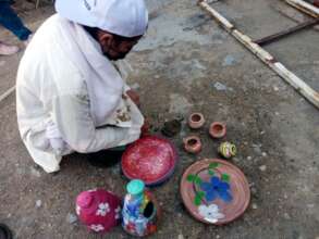 a student representing the role of potter