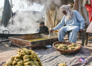 Ghulam Haider at work making Jaggery