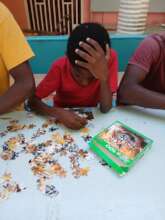 Former street child doing a puzzle