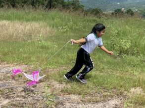 Semillas student running with kite