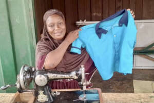 A seamstress sews a school uniform.