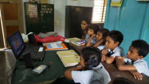 Schoolchildren and teacher watching AniBook story