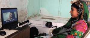 Woman watching SLS program in rural India