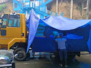 Loading supplies in the rain ahead of distribution