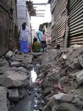 Dr Mune making visit to girls in slum
