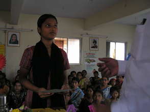 Priti receiving her computer skills certificate