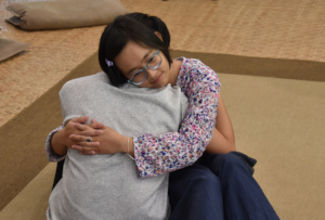 Two Participants Embrace in a Listening Session