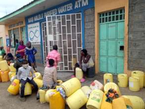 Community members gather to fetch water.