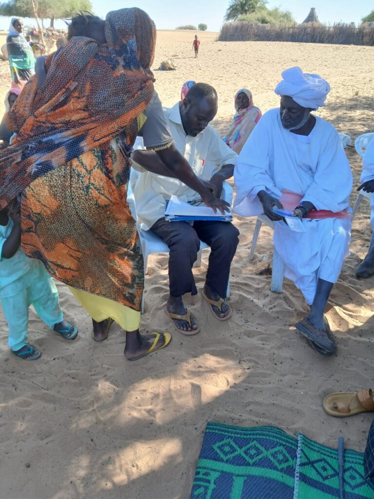 A Mother Signs Receipt with her Thumbprint