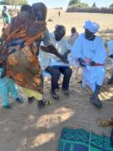 A Mother Signs Receipt with her Thumbprint