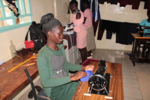 Trainees assisting in making school Uniforms