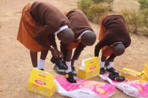 Girls trying out new pairs of toughees shoes