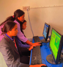 Fellow helping students with SCRATCH programming