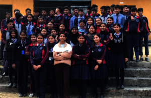 A WLiT fellow with students after program