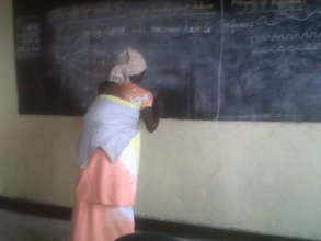 A woman in literacy class in Kibati center,
