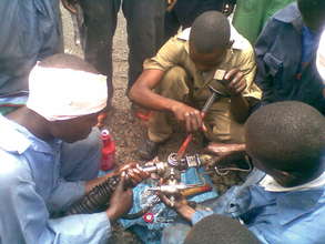 With collegues, Kakule learns mechanic