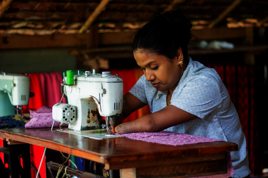 Zin sews diligently as her machine.