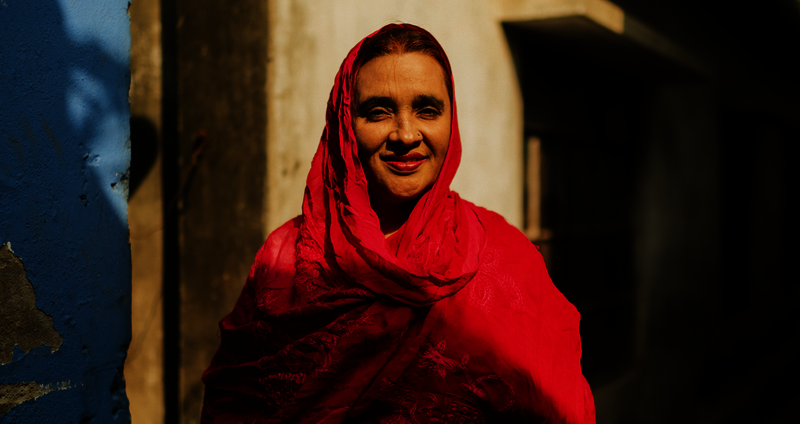 Jhorna stands proudly in front of her shop.