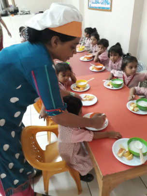 Kitchen in charge helping students