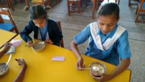 Girls eating in the new safe utensils