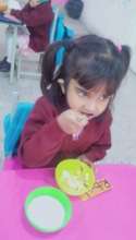 A student at SMB enjoys a breakfast meal at school