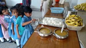 Grade 1 queuing up for their daily nutritious dose