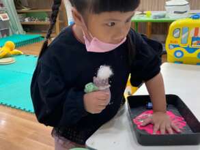 Stamping my hand in pink paint!