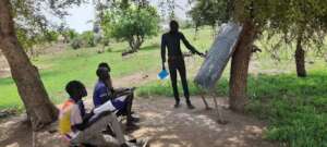 Pupils attending classes under trees