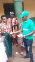 Our Project Leader giving out money to the widows