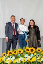 Student receiving her 6th grade diploma