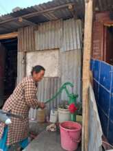 Clean water and a hopeful woman in Manohara.