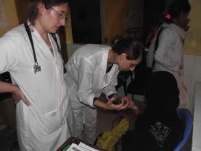 Dr. Ekaterine and Dr. Nada helping a tiny patient