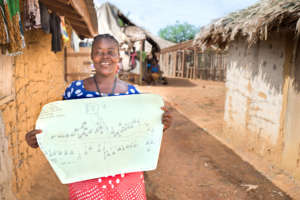 Grace poses with a map of her remote community
