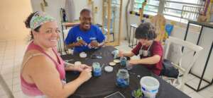 Volunteers making their own jewelry