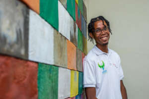 Eldrick in front of the plastic brick wall