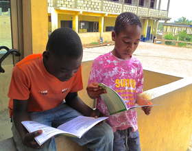 Kwesi and Derek enjoy reading their new textbooks!