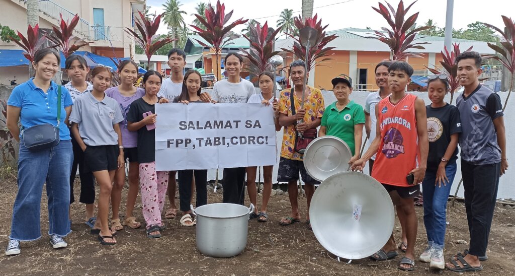 A youth volunteer group receives a kitchen set