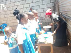 Pupils in a queue to be served Lunch