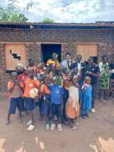 Children in front of dormitory that needs repairs