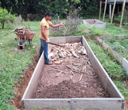 Young leader preparing a raised garden bed