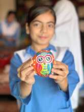 Painting pebbles as part of The Happiness Project